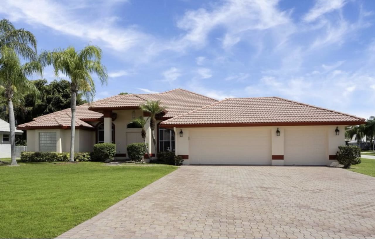 The stucco home before MH Home Improvement repainted the exterior.